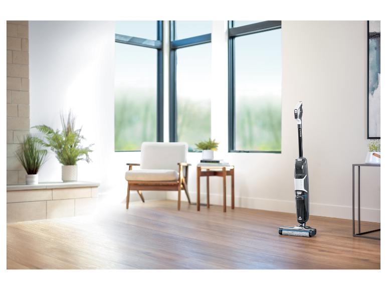 Bissell CrossWave stofzuiger in een lichte woonkamer met houten vloeren.