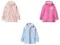Trois vestes de pluie pour enfants : rose à cœurs, fuchsia à licornes et bleu clair à cœur.