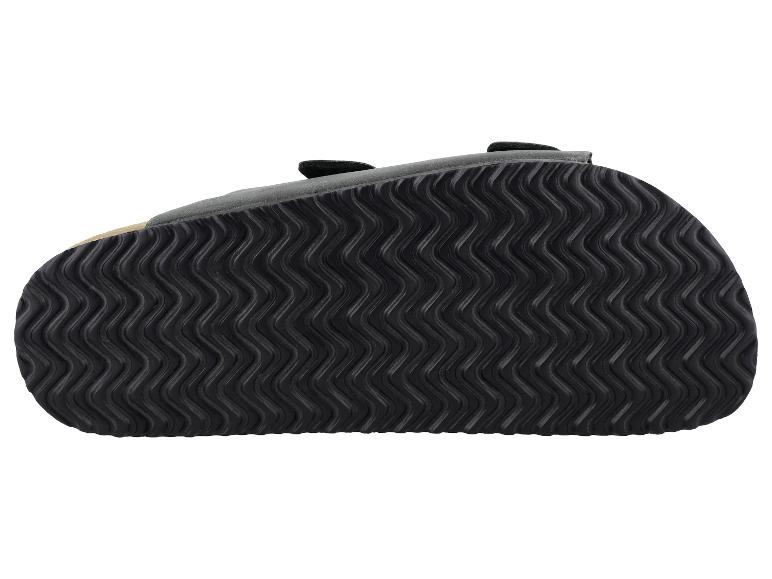 Sandale noire avec motif de semelle ondulé, vue de dessous