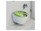 Een toilet met een groene zitting met bladeren en stenen