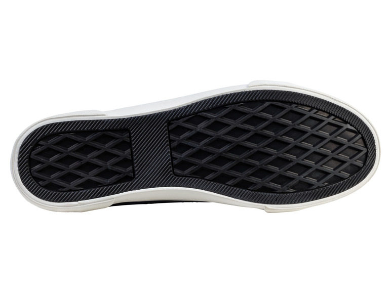De zool van een witte sneaker met een ruitpatroon.
