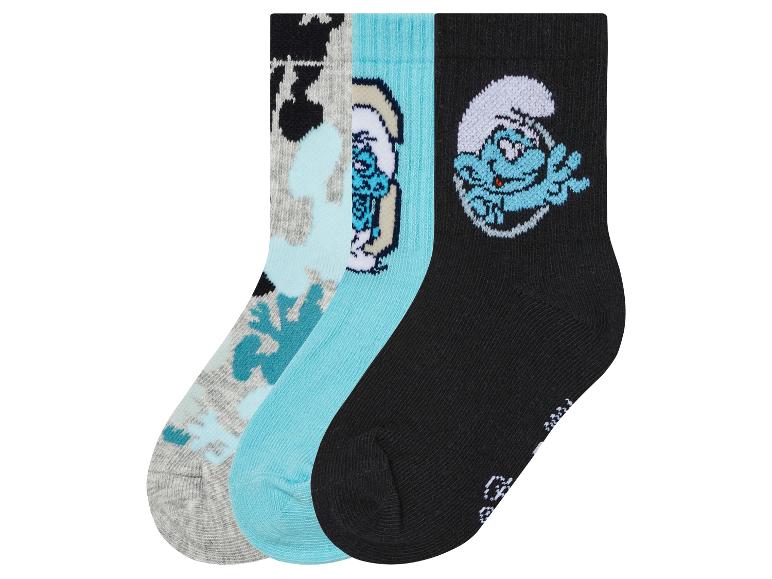 Trois paires de chaussettes avec un motif de Schtroumpfs.