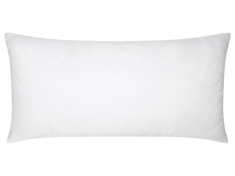 Oreiller blanc rectangulaire avec motif ondulé matelassé