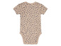 Un body bébé beige à pois bleus.