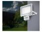 Un projecteur extérieur blanc avec détecteur de mouvement, fixé à un mur.