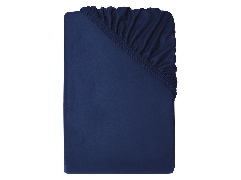 Drap-housse bleu foncé avec élastique, soigneusement plié.