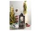 Lanterne de Noël avec figurine du Père Noël et sapin de Noël en arrière-plan
