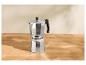 Cafetière moka avec du café moulu sur une table en bois.