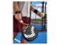 Padelracket en bal vastgehouden door een speler op een padelbaan.
