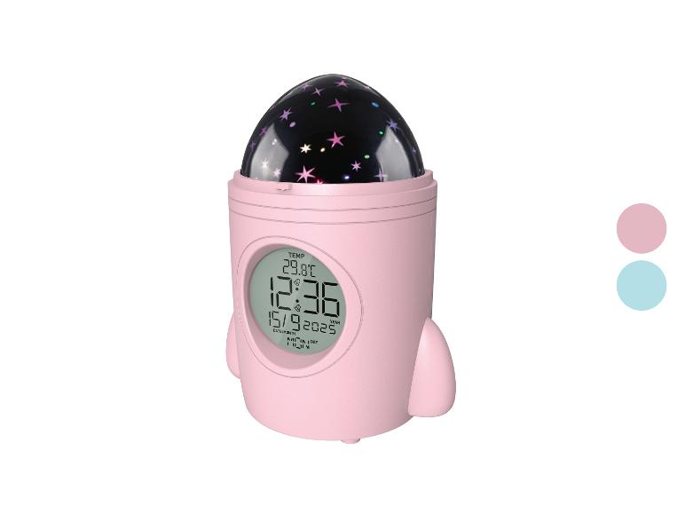Roze raketvormige wekker met sterrenprojectie en digitaal display.