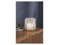 Une lanterne blanche avec une bougie LED sur un meuble en bois.
