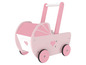 Une poussette en bois rose pour poupées avec des cœurs.
