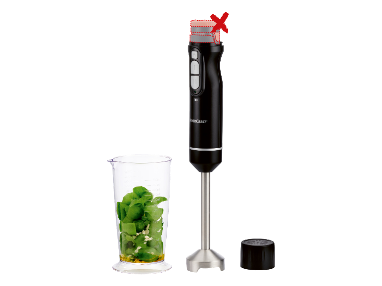 SILVERCREST® draadloze staafmixer met maatbeker gevuld met basilicum en knoflook.