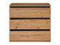 Commode trois tiroirs en bois clair avec séparations noires.