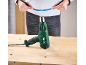 Pistolet thermique vert sur un établi en bois, avec une personne tenant un câble bleu.