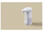 Witte automatische zeepdispenser op een beige achtergrond