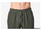 Donkergroene, losvallende shorts met trekkoord in de taille, getoond vanaf de taille naar beneden.