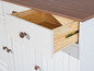 Een witte dressoir met een open lade met houten binnenkant.