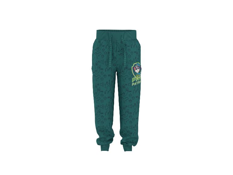 Kinder joggingbroek in teal met dinosauruspatroon en cartoonfiguur.