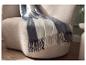 Plaid LIVARNO home à franges drapé sur un fauteuil moderne