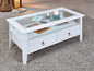 Witte salontafel met glazen blad, twee laden en een open plank.