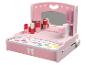 Coiffeuse rose pour enfants avec miroir, cosmétiques et accessoires.