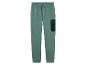 Groene joggingbroek met een zak op de dij.