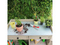 Tuintafel met planten, gereedschap en potgrond.