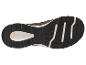 Semelle d'une chaussure de sport verte avec bande de roulement noire et accents blancs.