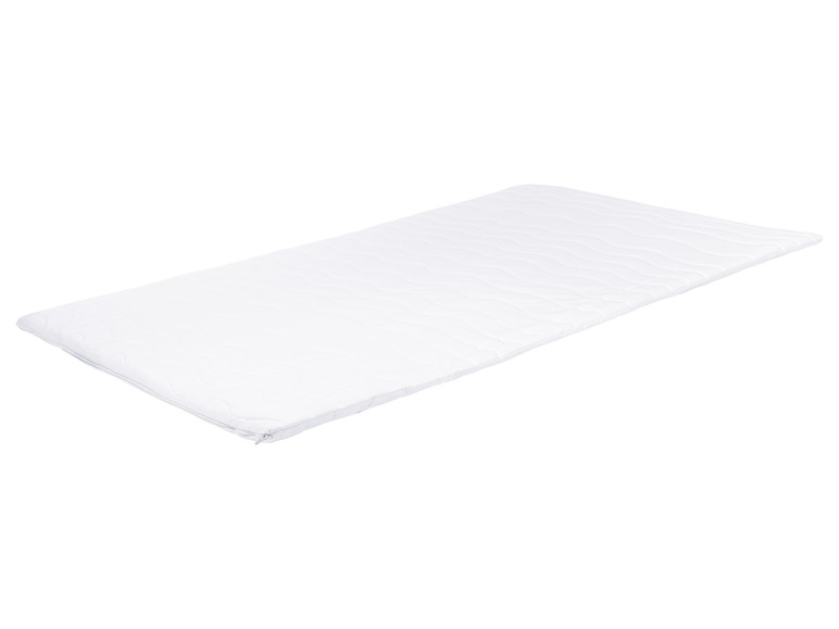 Un matelas blanc avec un motif ondulé.