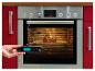 Grill Meister vleesthermometer toont 76,5, met een braadstuk in de oven.