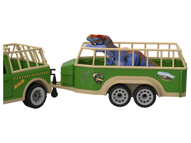 Une jeep verte avec une remorque, contenant un T-Rex.
