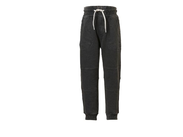 Pantalon de jogging gris foncé avec cordon blanc et détails de couture.