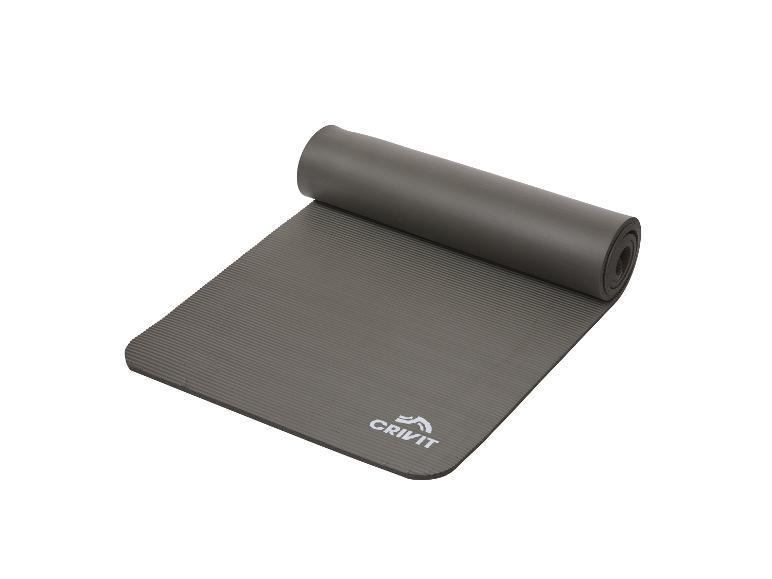 Tapis d'exercice Crivit gris, partiellement enroulé.