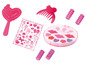 Un ensemble de maquillage rose avec du rouge à lèvres, des bigoudis et des accessoires.