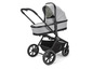 Een grijze kinderwagen met zwarte wielen en een Valco Baby-logo.