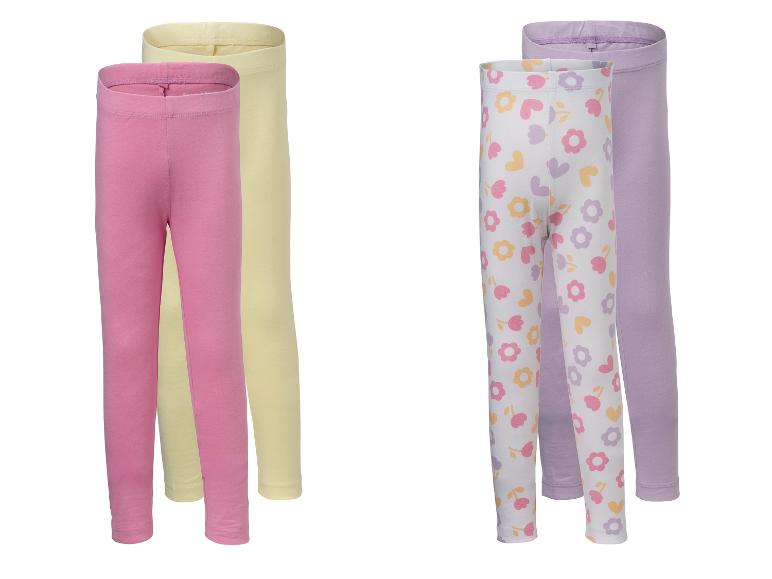 Twee paar kinderleggings: roze en geel, en wit bloemen met paars.