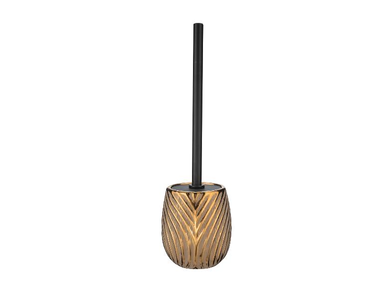 Brosse de toilette dorée avec manche noir.