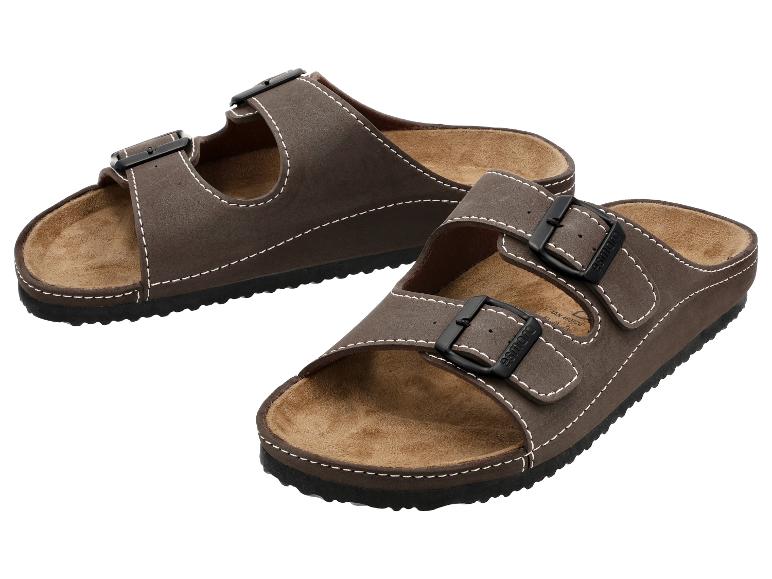 Sandales marron à deux brides avec boucles noires, avec surpiqûres blanches.
