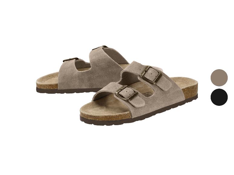 Sandales en daim avec boucles ajustables et semelle en liège, disponibles en beige et noir.