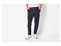Man draagt donkerblauwe joggingbroek met trekkoord en witte sneakers.