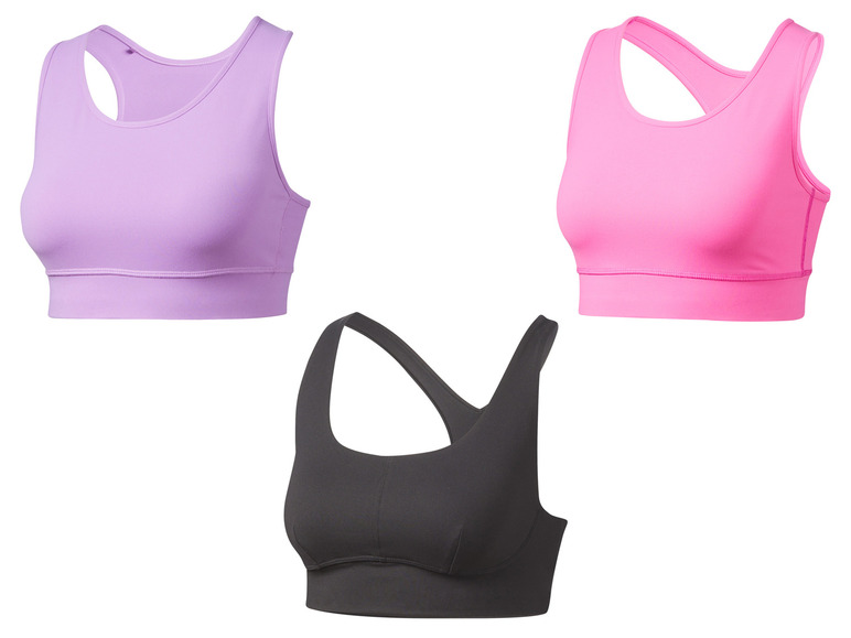 Drie sportbeha's in verschillende kleuren: paars, roze en zwart.