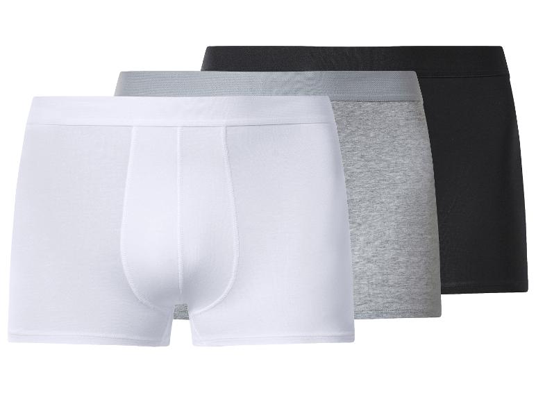Trois boxers pour hommes en blanc, gris et noir.