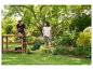 Paar in de tuin met grasmaaier, trimmer en grasschaar.