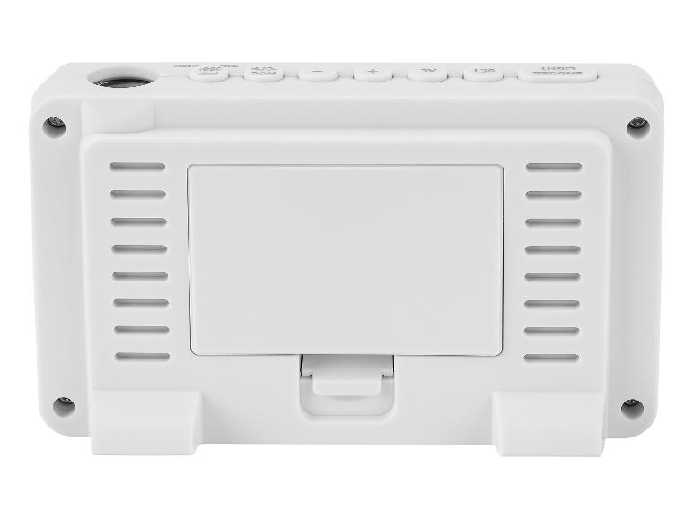 Arrière d'un réveil projecteur blanc avec des boutons pour snooze, lumière, réglage, alarme, plus et moins.