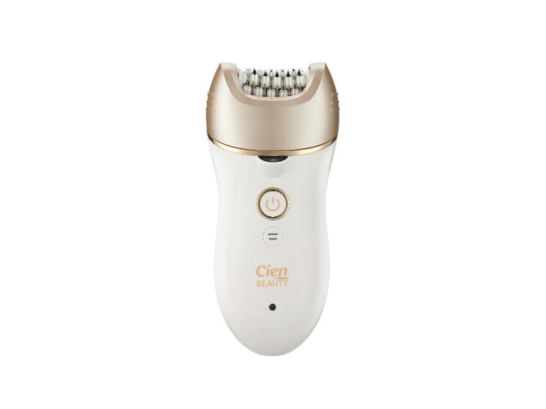 Épilateur blanc avec une tête couleur or champagne et des boutons de commande.