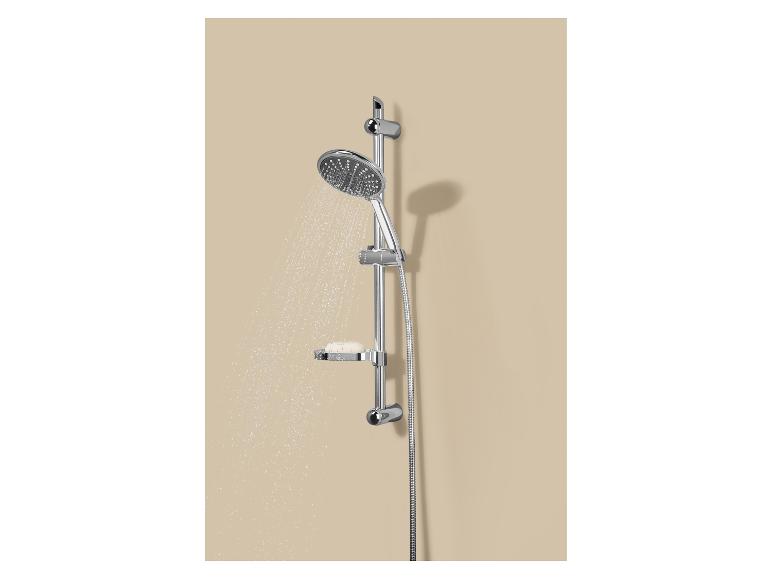 Doucheset met zeepbakje, water stroomt, gemonteerd op een beige muur.