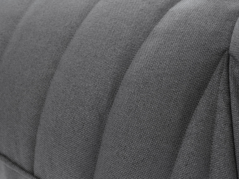 Close-up van de textuur van een grijze stoffen bank.