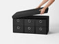 Un banc de rangement noir avec six tiroirs.