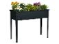 Jardinière surélevée rectangulaire noire avec un assortiment de fleurs colorées